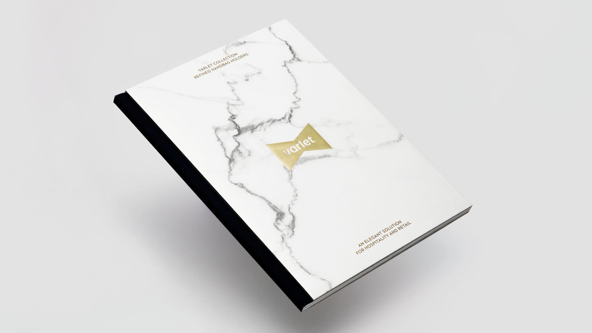 Foto d'un llibre de l'empresa de mobiliari de disseny VARLET on es presenta el naming i el branding de la marca. Dissenyat per l'estudi esiete de branding i comunicaci&oacute; de Barcelona.