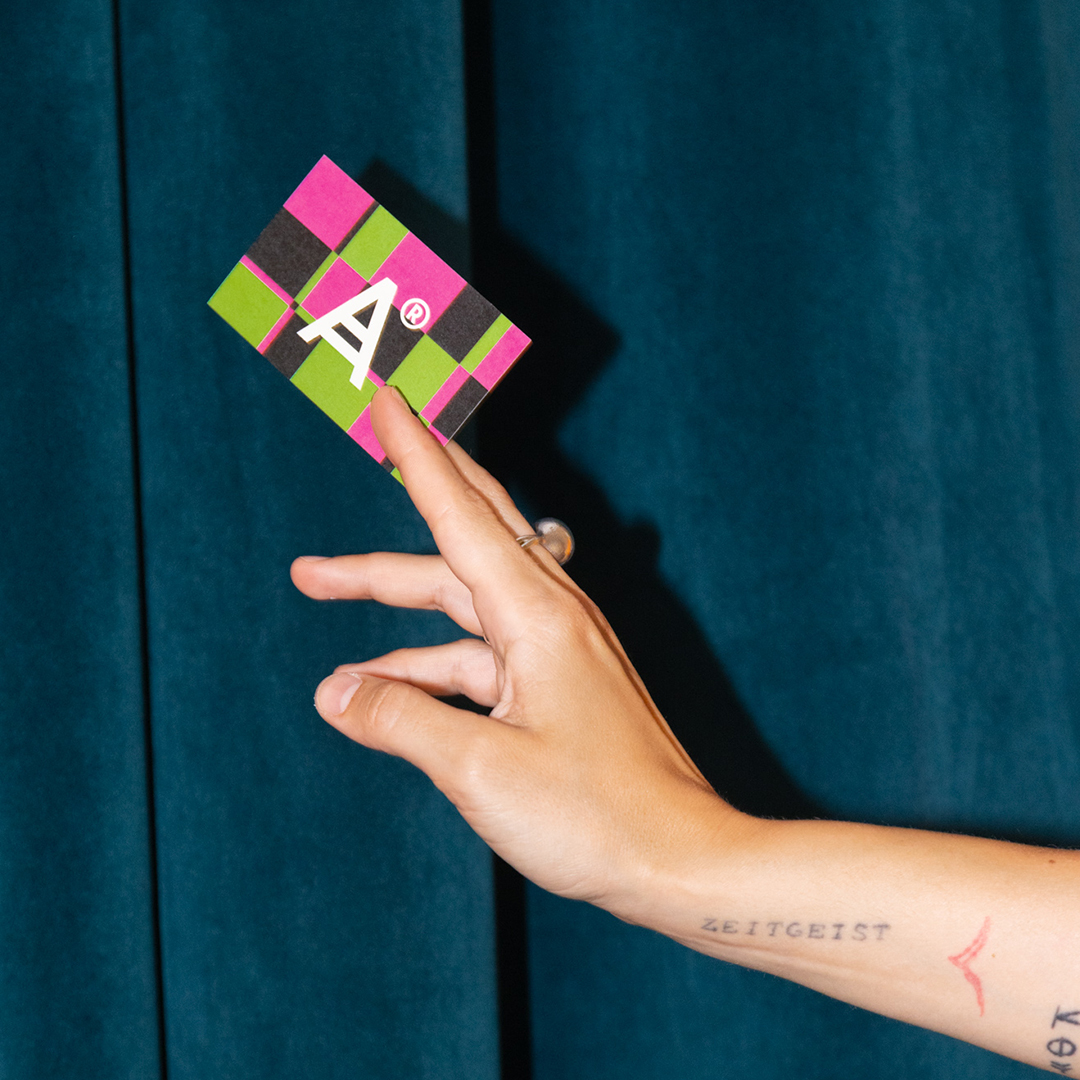 <span><span>A girl holding a black and white tote or paper bag contains the ATELIER RESISTANCE&rsquo;s icon or symbol with registration mark. Designed by Esiete branding and communication design studio/agency Barcelona </span></span>